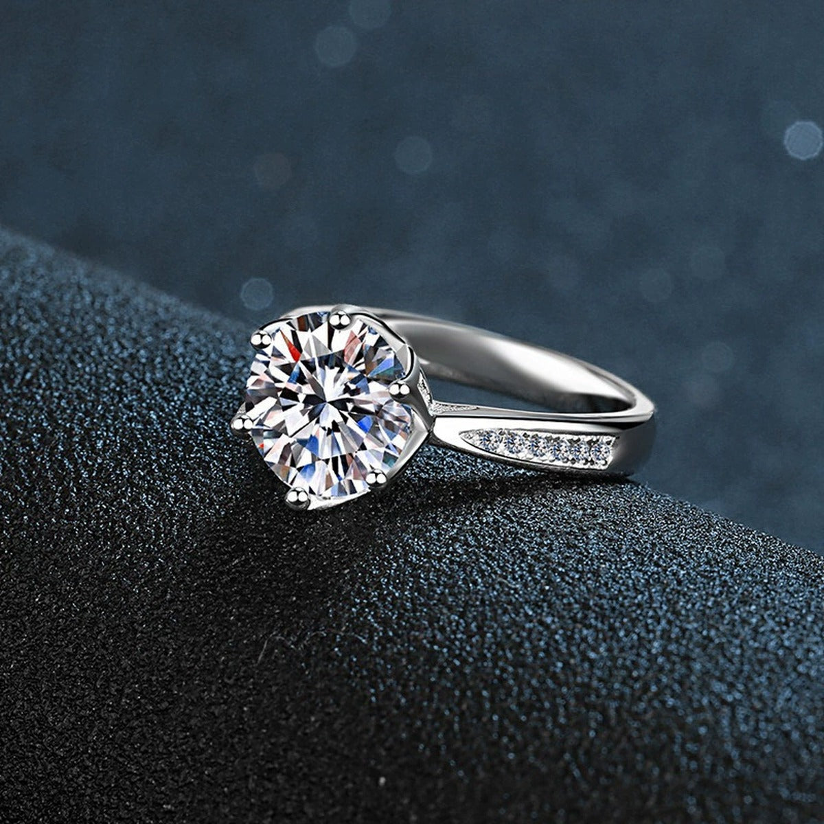 Six-Prong Round Moissanite Engagement Ring with CZ close-up detail view with moissanite sparkle