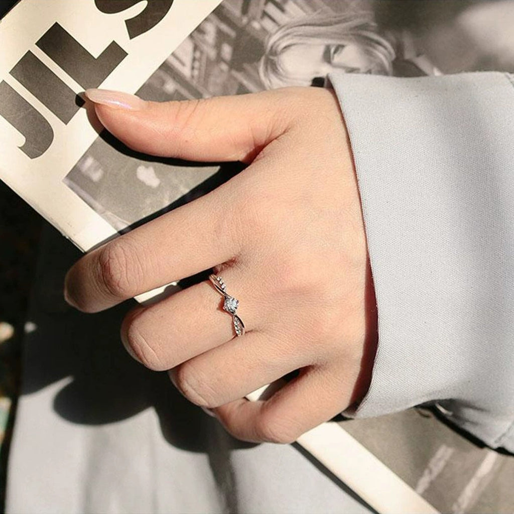 Round Moissanite Twist Engagement Ring with CZ worn on hand to show scale, band width, and ring profile