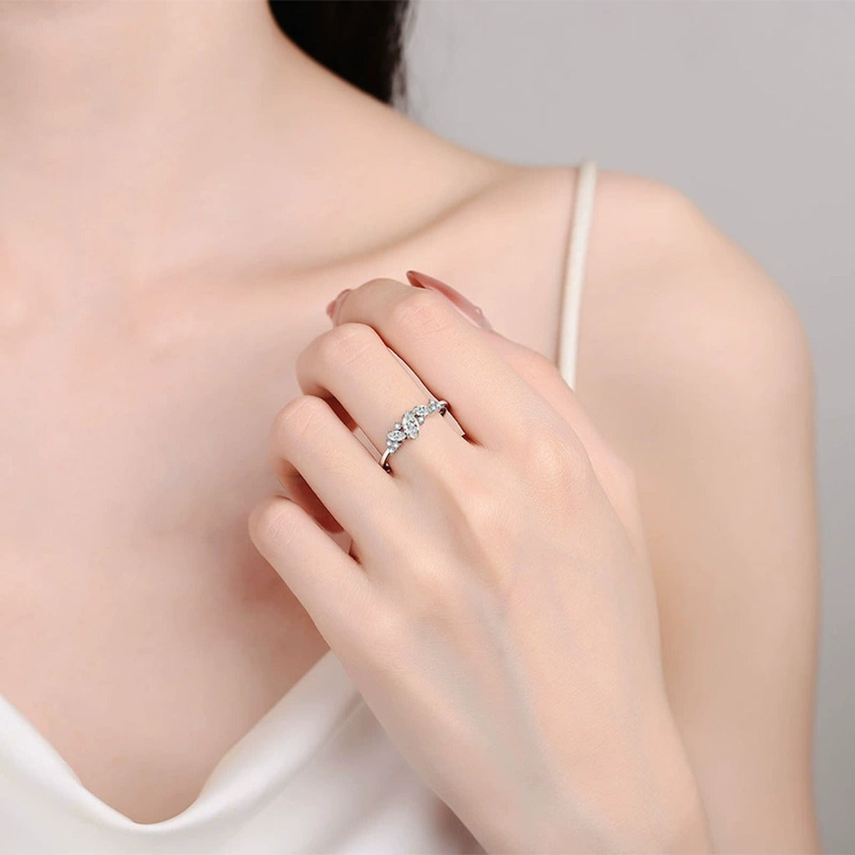 Marquise Cut Moissanite Wedding Ring with CZ worn on hand to show scale, band width, and ring profile