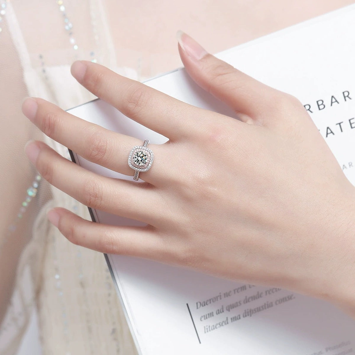 Pink CZ Halo Round Moissanite Engagement Ring worn on hand to show scale, band width, and ring profile