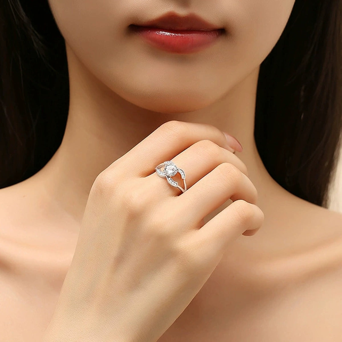 Four-Prong Round Moissanite Adjustable Engagement Ring with CZ worn on hand to show scale, band width, and ring profile