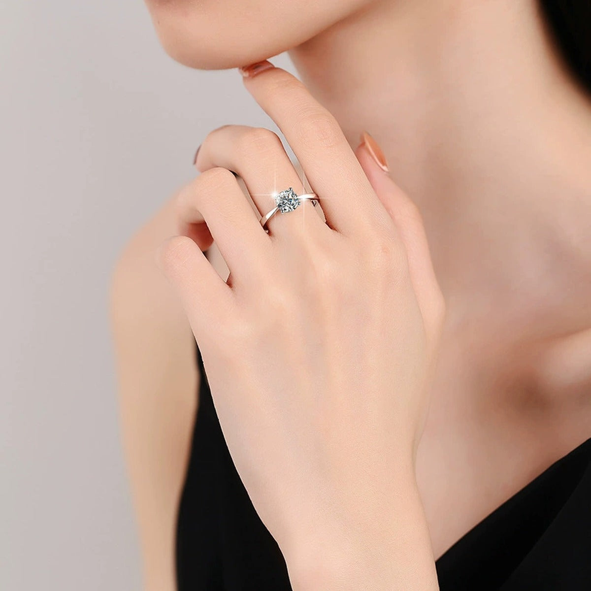 Four-Prong Round Moissanite Adjustable Solitaire Engagement Ring worn on hand to show scale, band width, and ring profile
