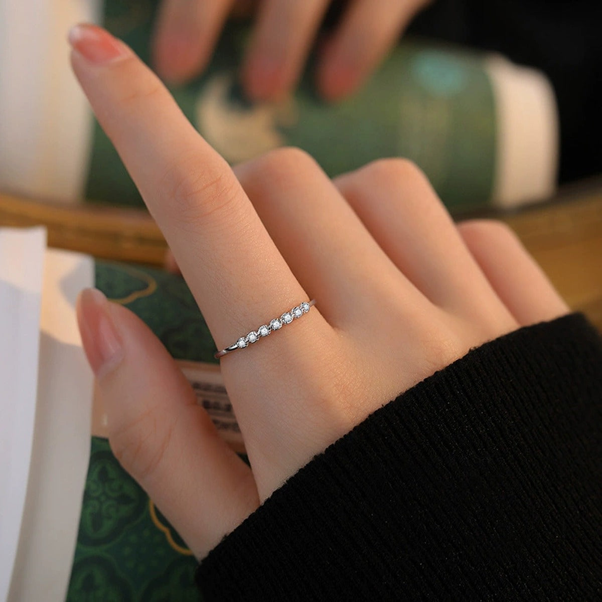 Bezel Round Moissanite Adjustable Wedding Band worn on hand to show scale, band width, and ring profile
