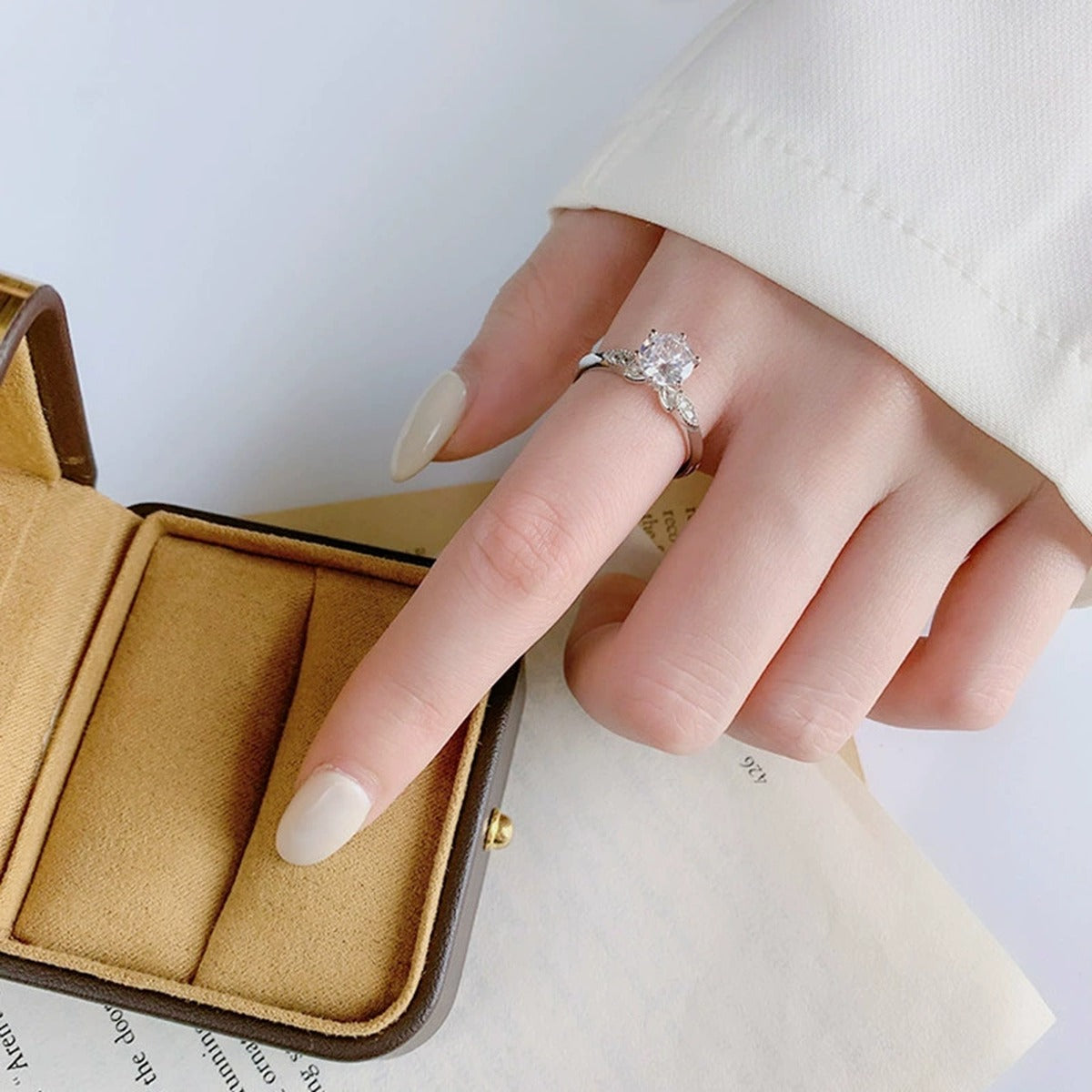 Six-Prong Round Moissanite Adjustable Engagement Ring with CZ worn on hand to show scale, band width, and ring profile