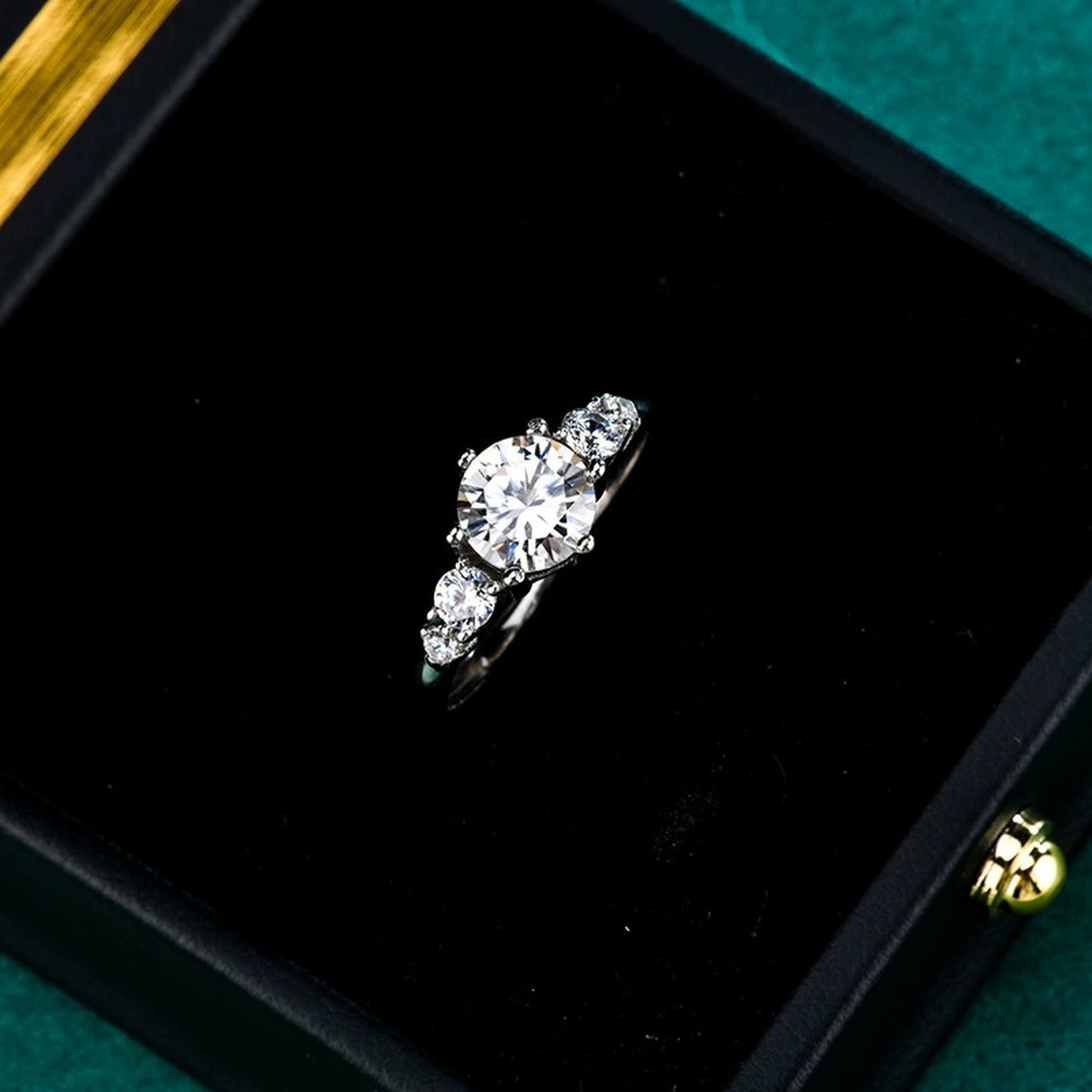 Three-Stone Round Moissanite Engagement Ring with CZ close-up detail view with moissanite sparkle