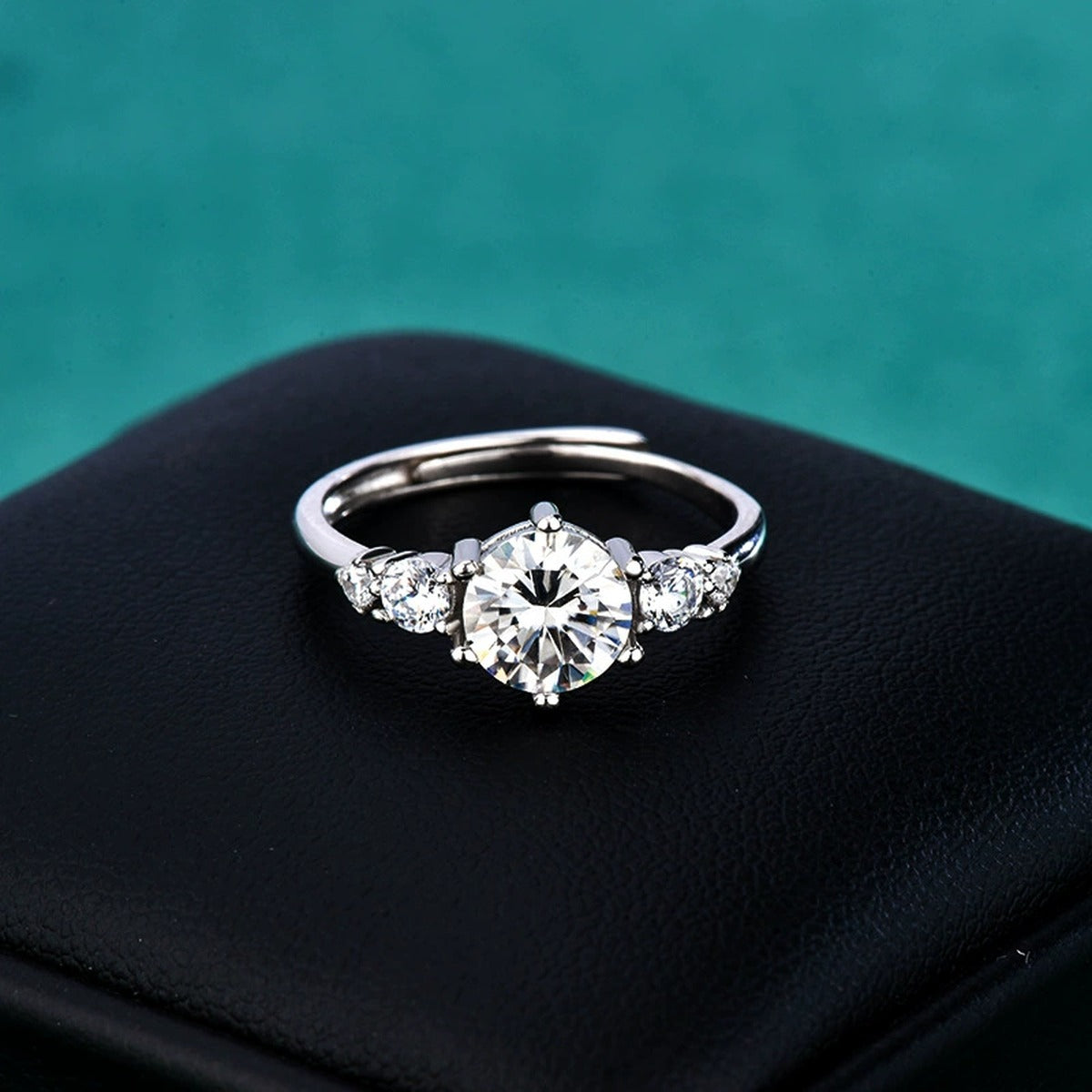 Three-Stone Round Moissanite Engagement Ring with CZ close-up detail view with moissanite sparkle