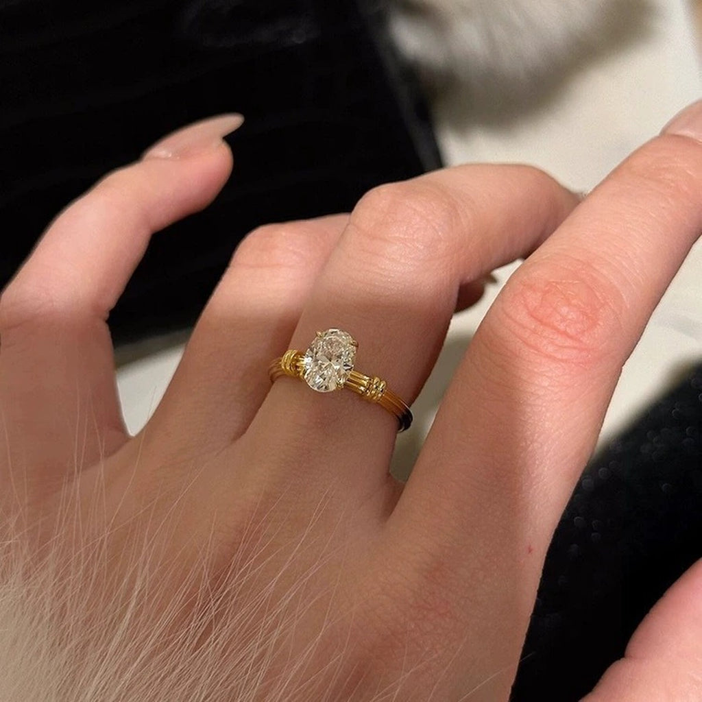 Oval Cut Moissanite Solitaire Engagement Ring in Yellow Gold-Plated S925 Sterling Silver worn on hand to show scale, band width, and ring profile