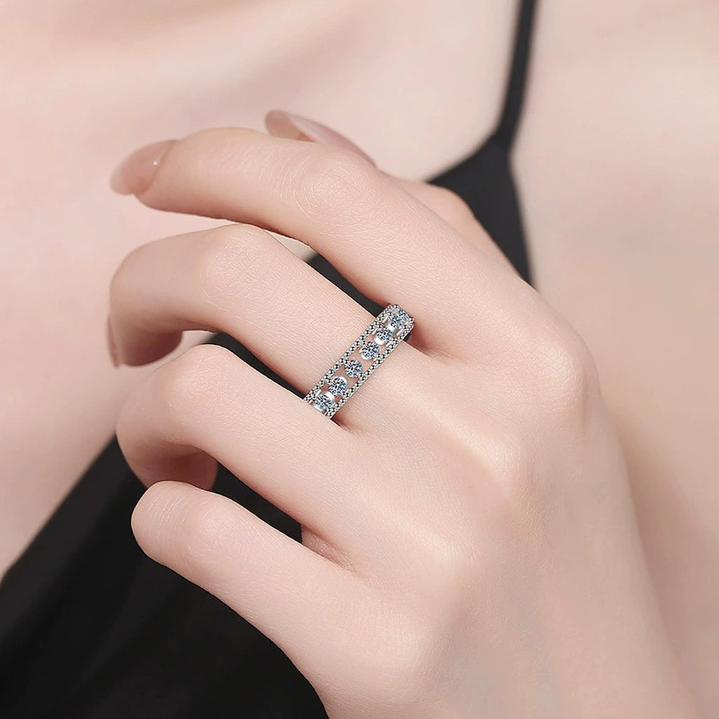 Pave Round Moissanite Eternity Wedding Band worn on hand to show scale, band width, and ring profile