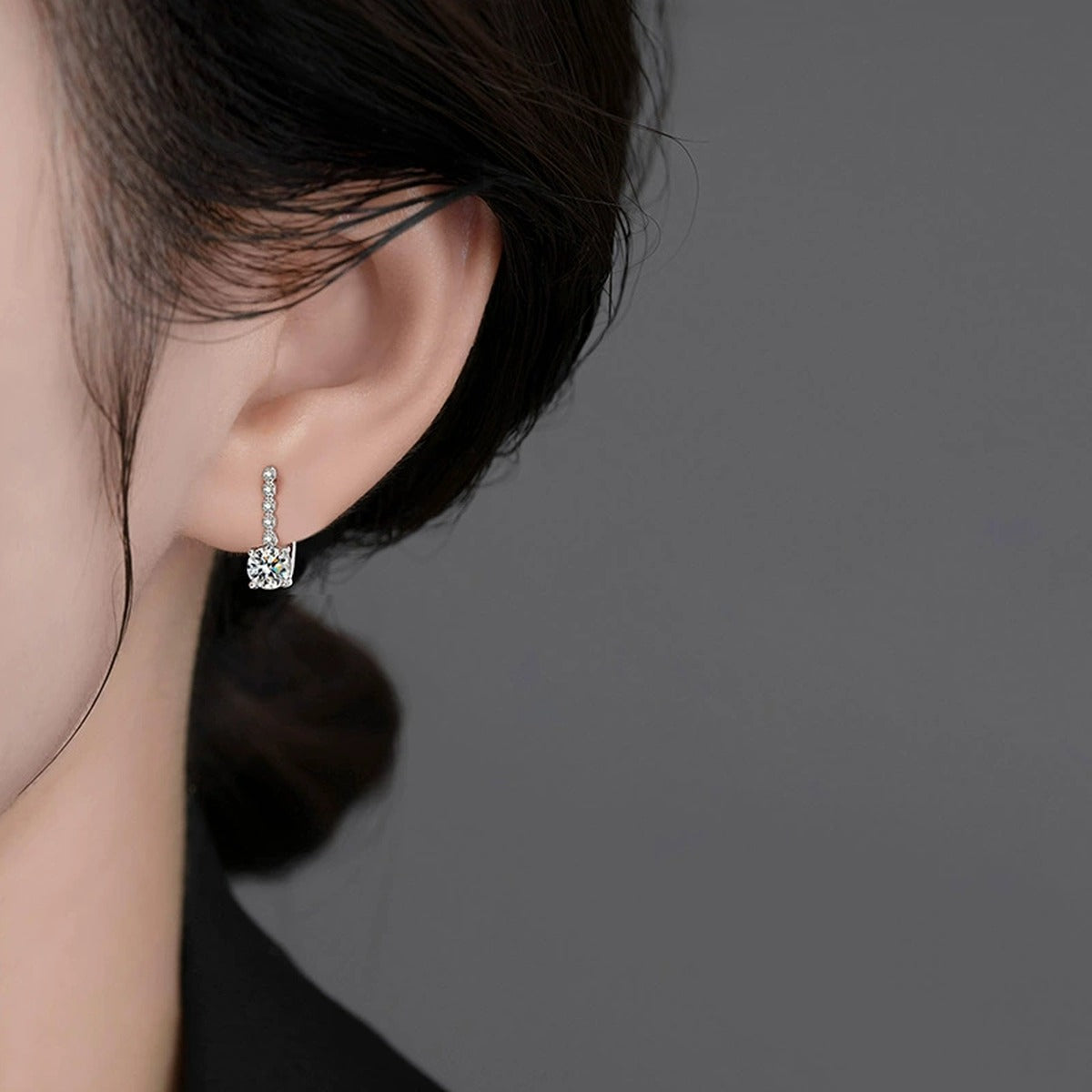 Colored Round Moissanite Huggie Hoop Earrings with CZ in White Gold-Plated S925 sterling silver worn on ear by model showing scale, placement, and huggie hoop earrings styling
