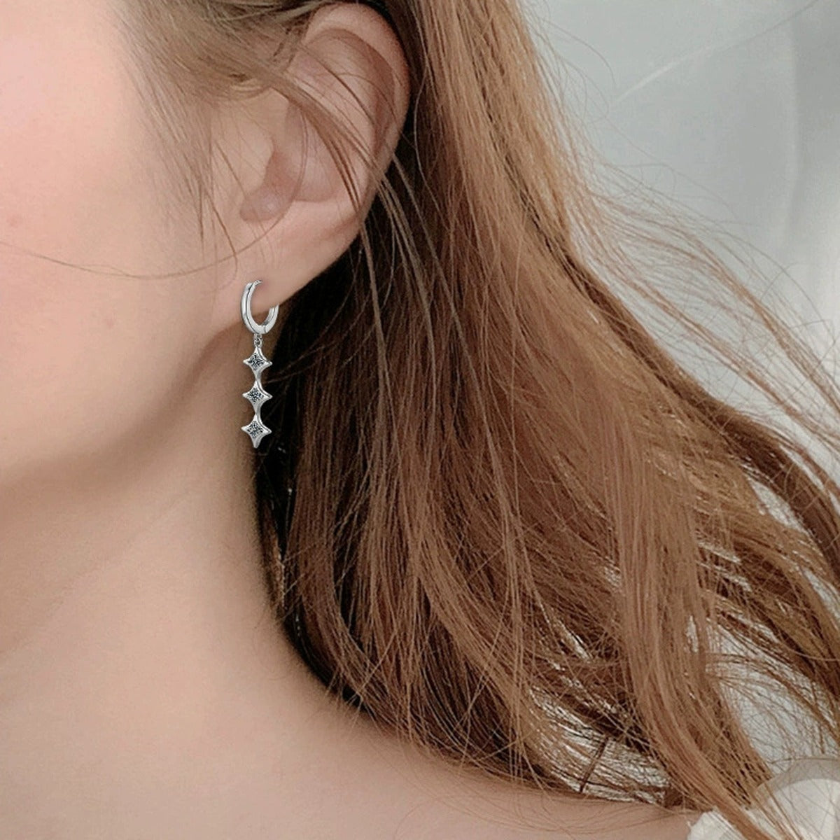 Star Moissanite Hoop Dangle Earrings in White Gold-Plated S925 sterling silver worn on ear by model showing scale, placement, and hoop dangle earrings styling