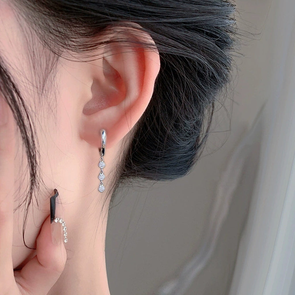 Graduated Round Moissanite Bead Hoop Dangle Earrings in White Gold-Plated S925 sterling silver worn on ear by model showing scale, placement, and hoop dangle earrings styling