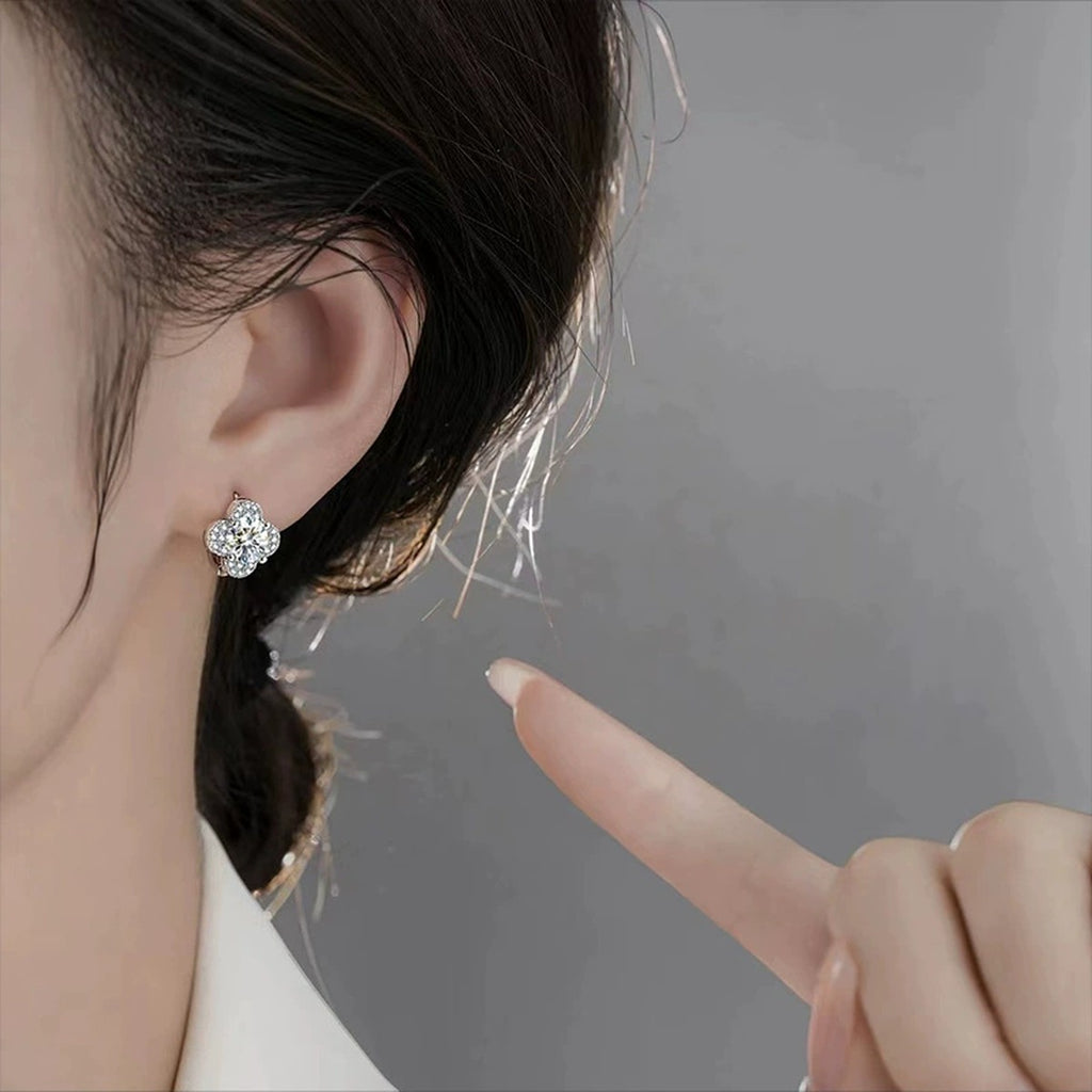 Four-Leaf Clover Round Moissanite Huggie Hoop Earrings with CZ in White Gold-Plated S925 sterling silver worn on ear by model showing scale, placement, and huggie hoop earrings styling