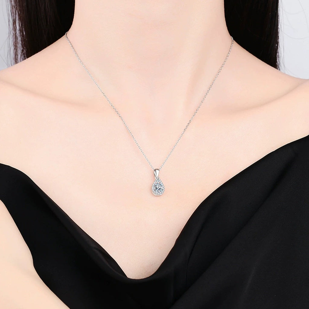 pear moissanite halo pendant necklace worn by model