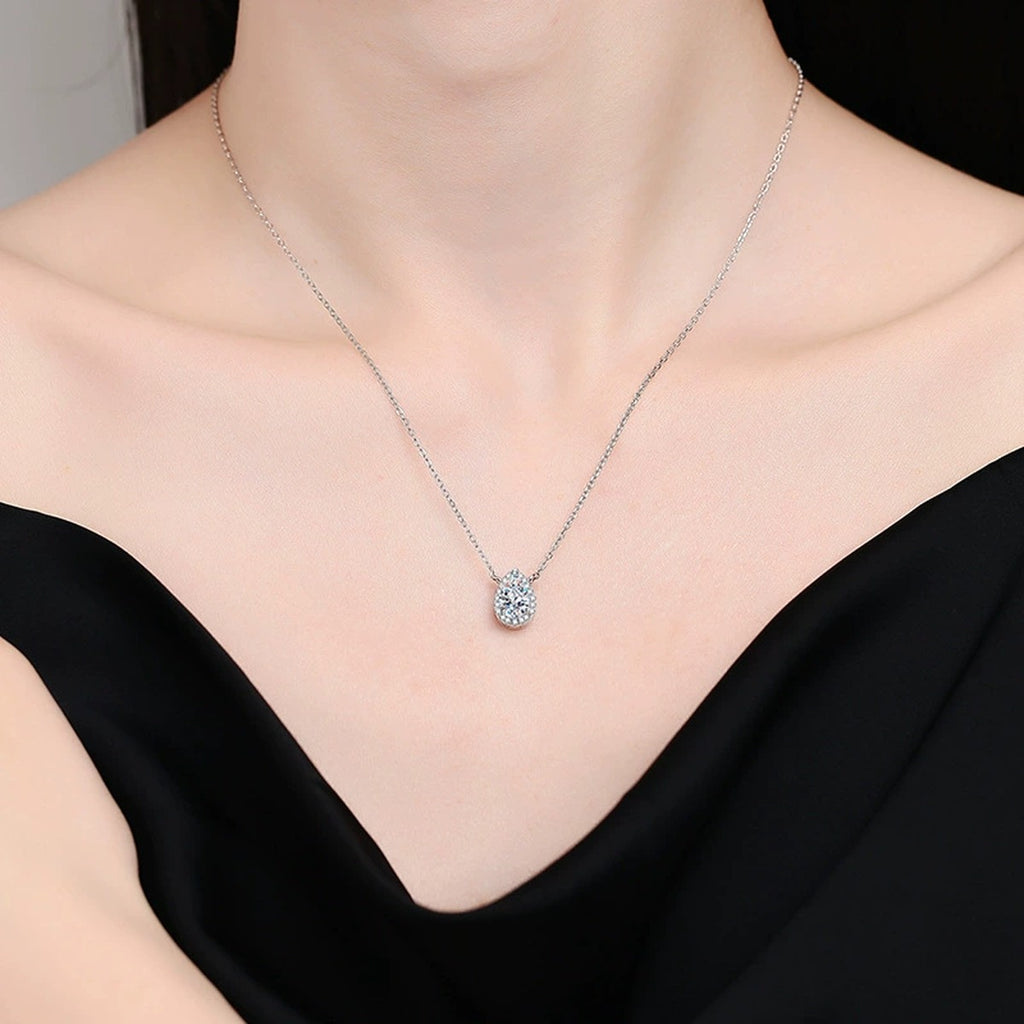 pear moissanite halo pendant necklace worn by model