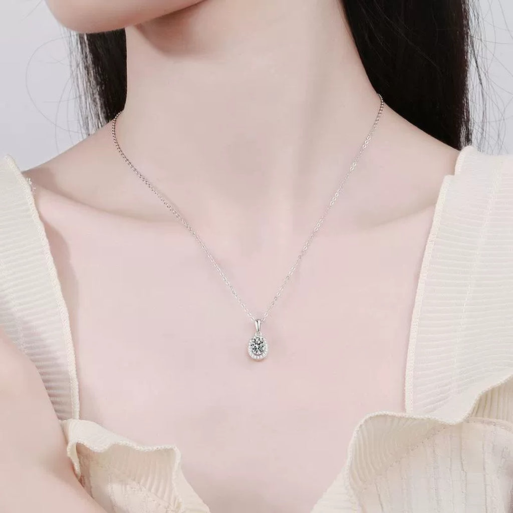oval moissanite halo pendant necklace worn by model