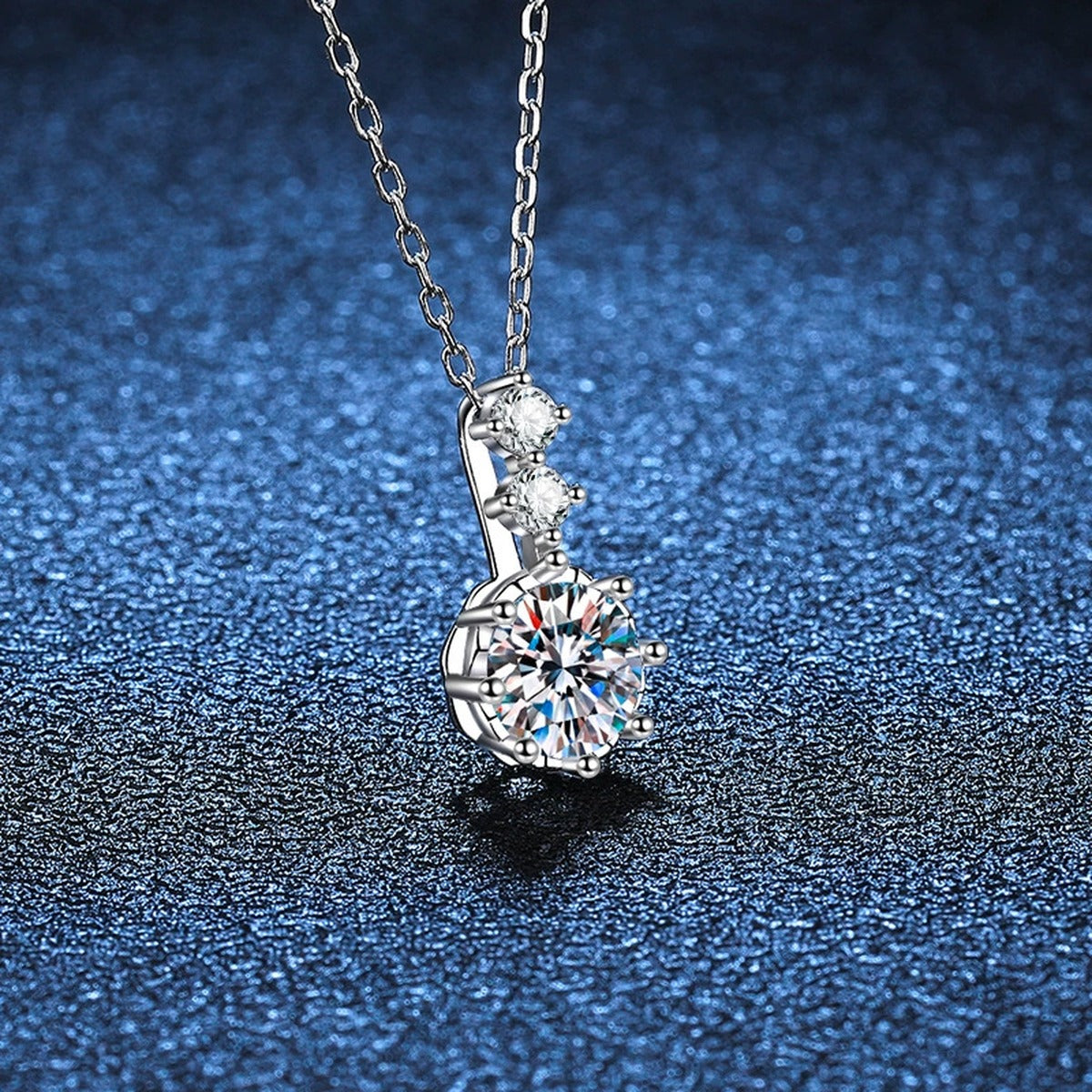 Round Moissanite Pendant Necklace with Cubic Zirconia in White Gold-Plated S925 Sterling Silver blue background angled view