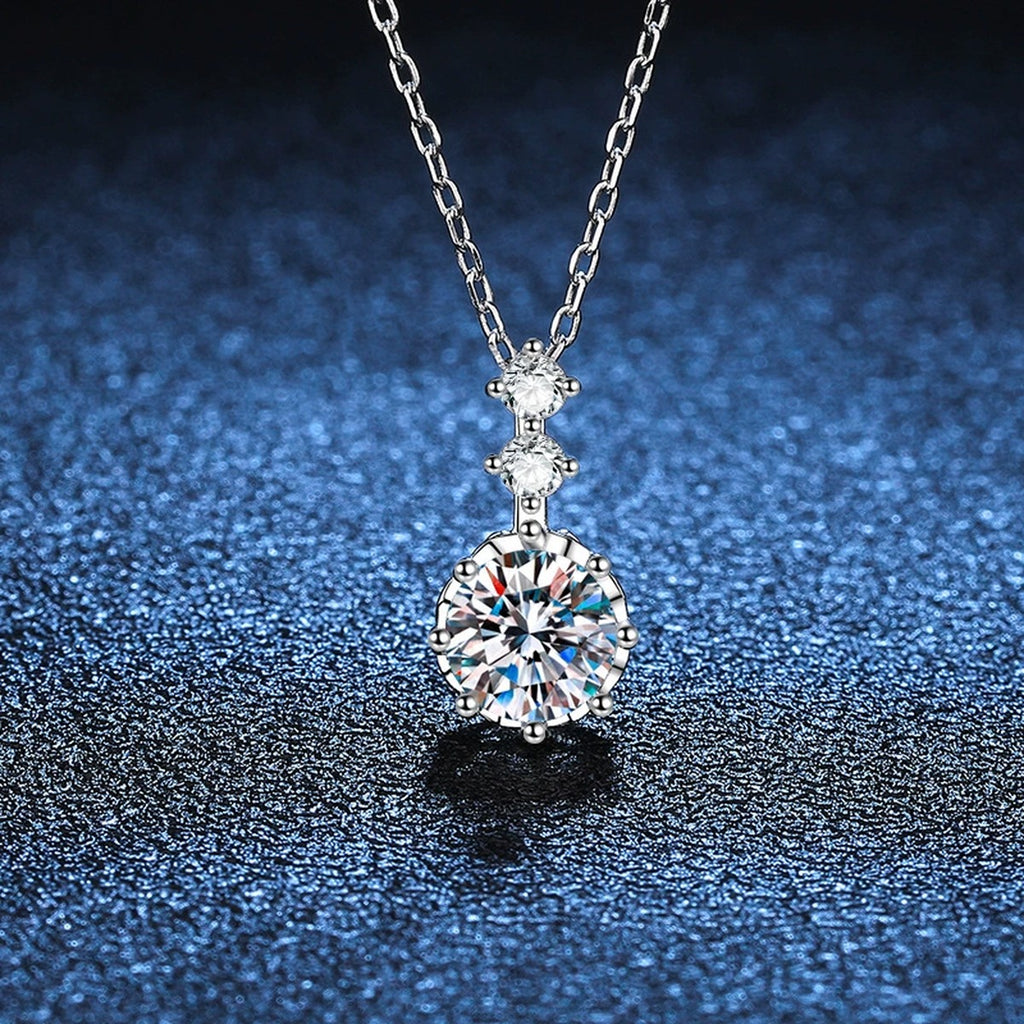 Round Moissanite Pendant Necklace with Cubic Zirconia in White Gold-Plated S925 Sterling Silver blue background close-up view