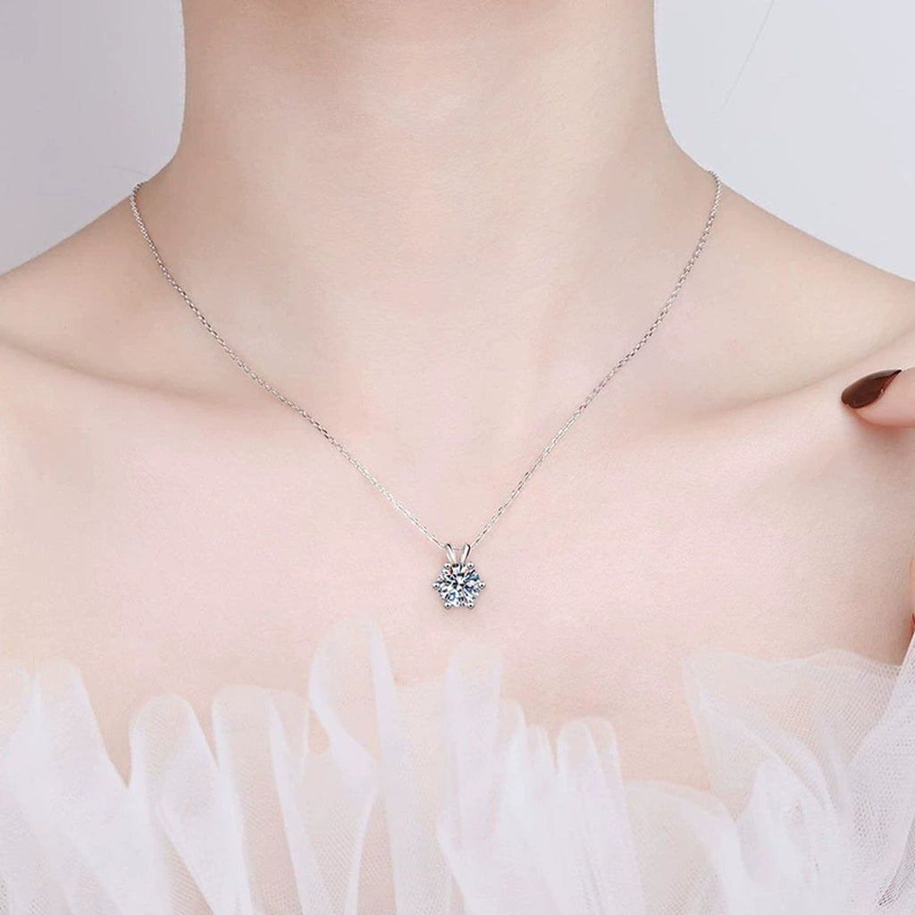 six-prong round moissanite pendant necklace in platinum-plated S925 sterling silver worn by model