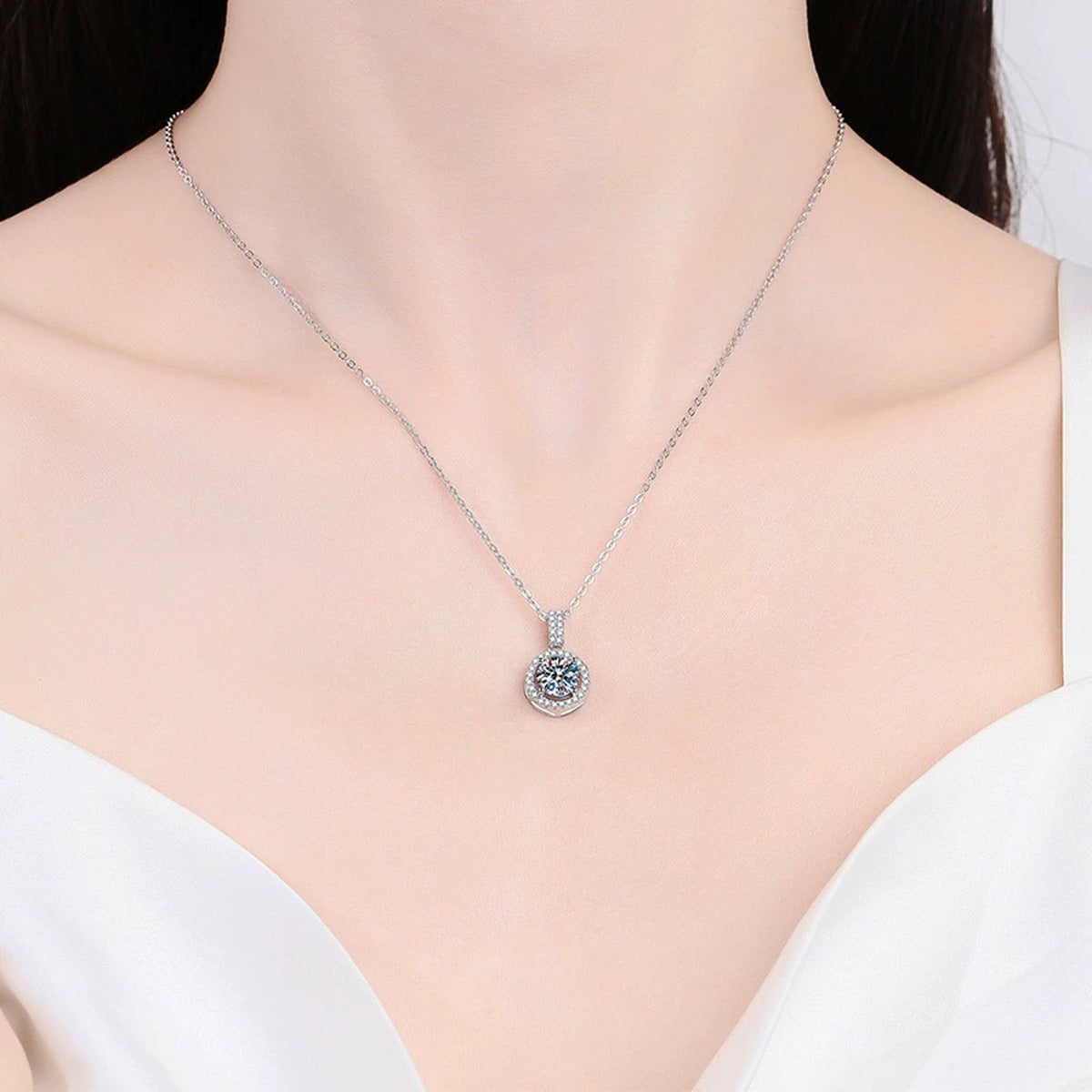 round halo moissanite pendant necklace with CZ accents in platinum-plated S925 sterling silver worn by model