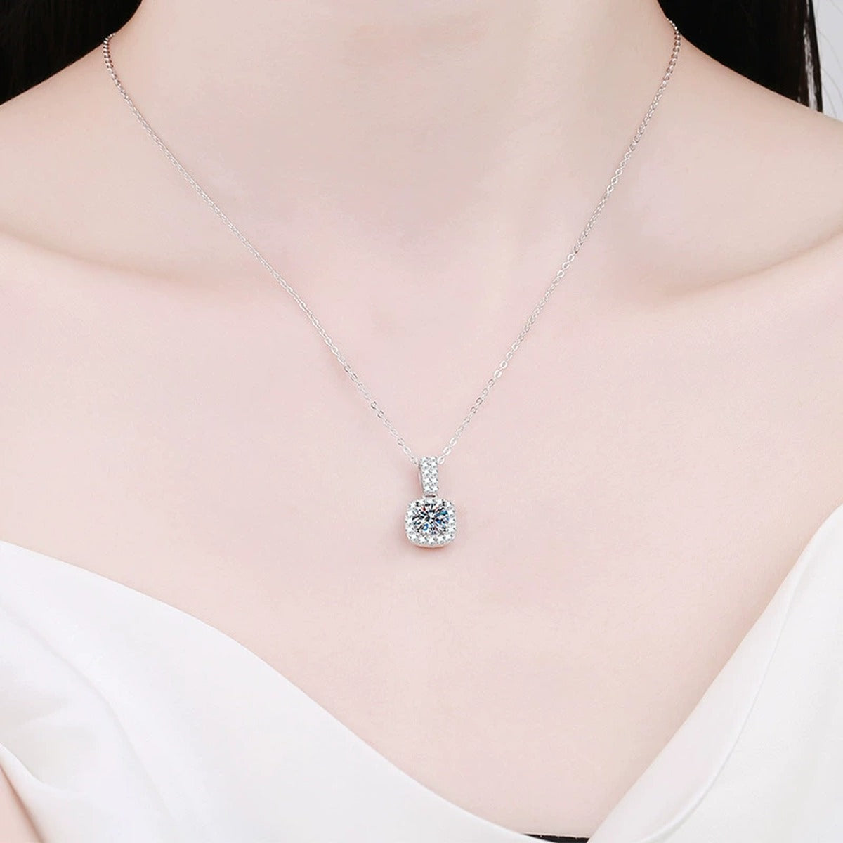 cushion halo moissanite pendant necklace with CZ accents in platinum-plated S925 sterling silver worn by model