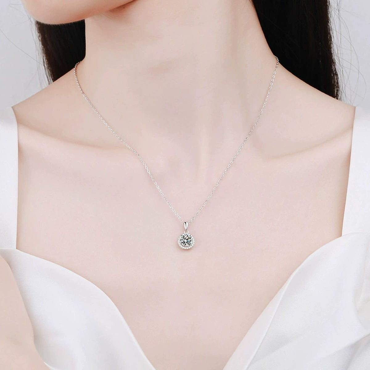 round halo moissanite pendant necklace with CZ accents in platinum-plated S925 sterling silver worn by model