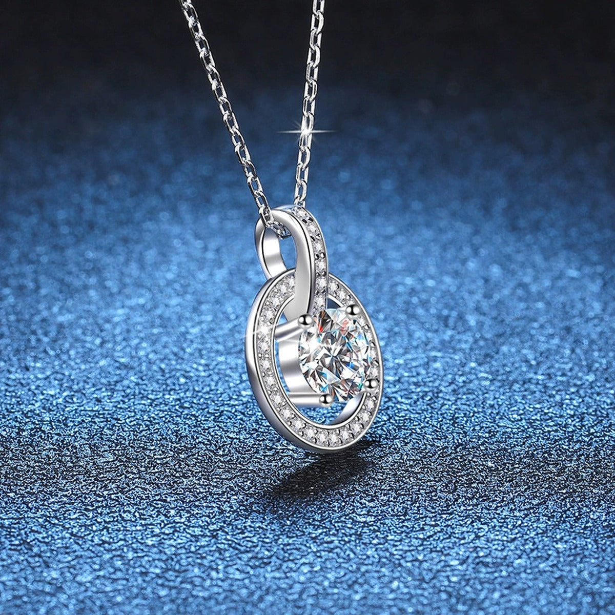 circle drop moissanite pendant necklace with CZ accents in platinum-plated S925 sterling silver close-up detail view
