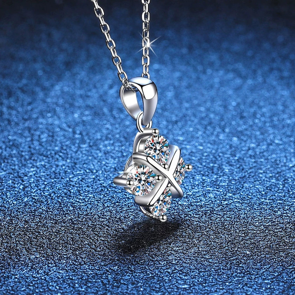 Four-Stone Clover Moissanite Pendant Necklace in Platinum-Plated S925 Sterling Silver blue background angled detail view