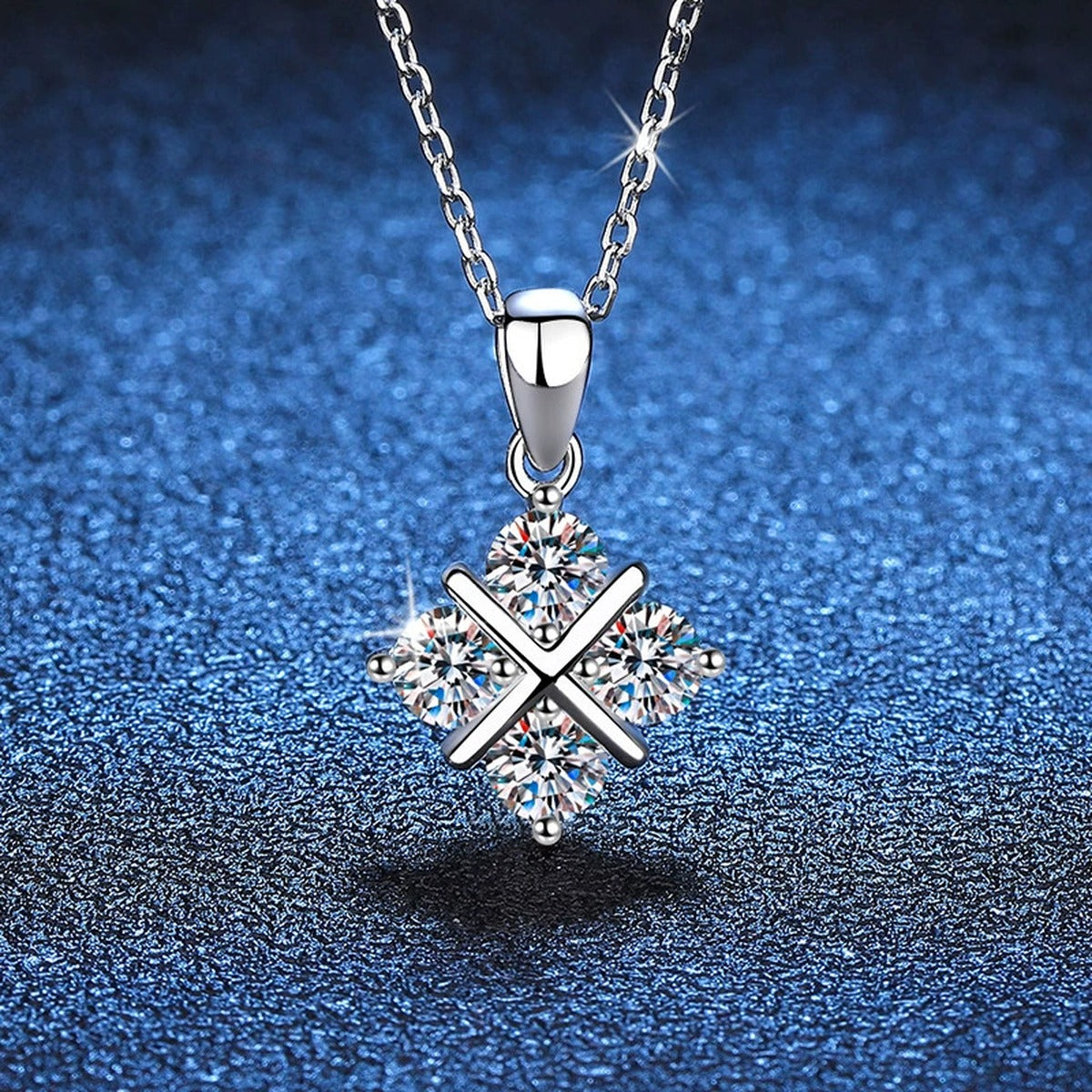 Four-Stone Clover Moissanite Pendant Necklace in Platinum-Plated S925 Sterling Silver blue background close-up view