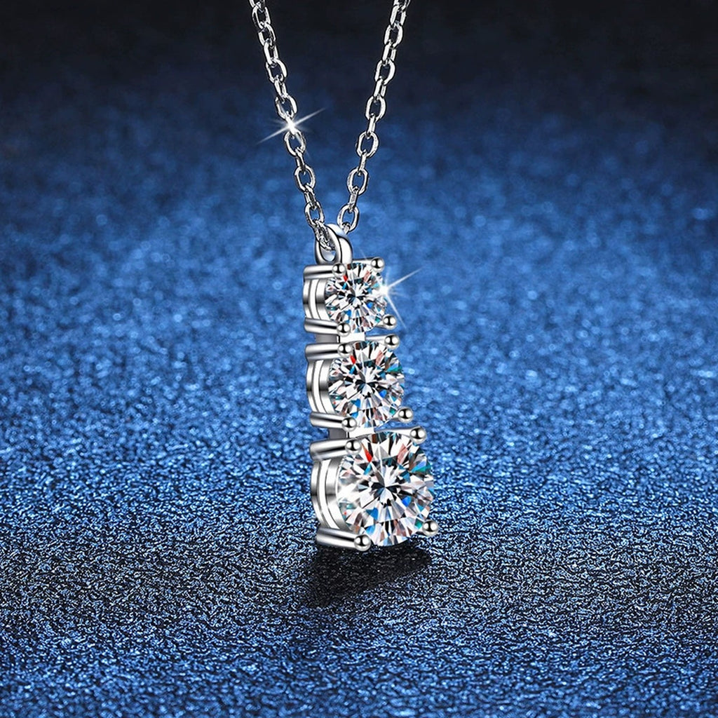 Graduated Three-Stone Moissanite Drop Necklace in Platinum-Plated S925 Sterling Silver blue background product view