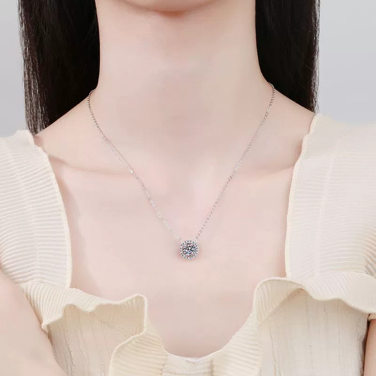 Round Halo Moissanite Pendant Necklace in Platinum-Plated S925 Sterling Silver worn by model at neckline