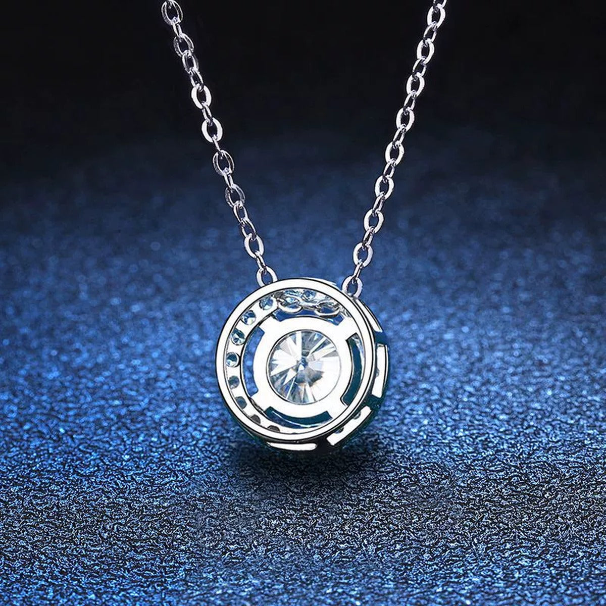 Round Halo Moissanite Pendant Necklace in Platinum-Plated S925 Sterling Silver blue background angled detail view
