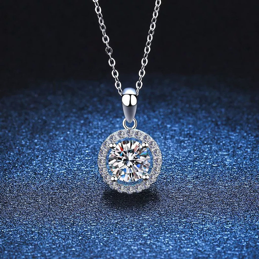 Round Halo Moissanite Pendant Necklace in Platinum-Plated S925 Sterling Silver blue background close-up view