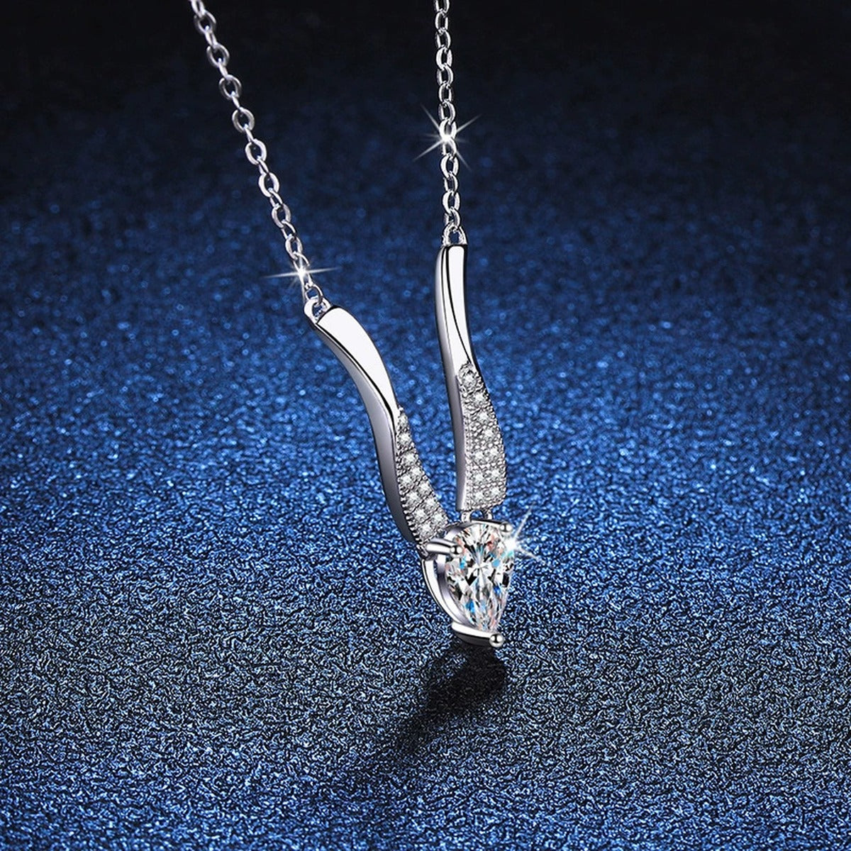 Pear Moissanite Drop Necklace in Platinum-Plated S925 Sterling Silver blue background angled detail view