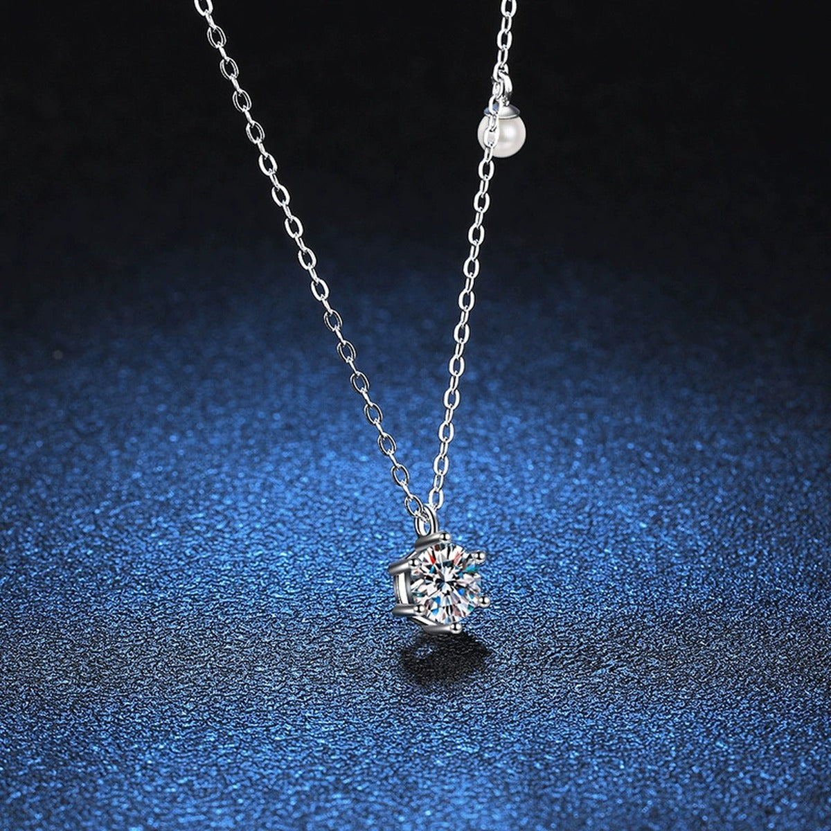 Round Moissanite Pearl Accent Pendant Necklace in Platinum-Plated S925 Sterling Silver blue background close-up view