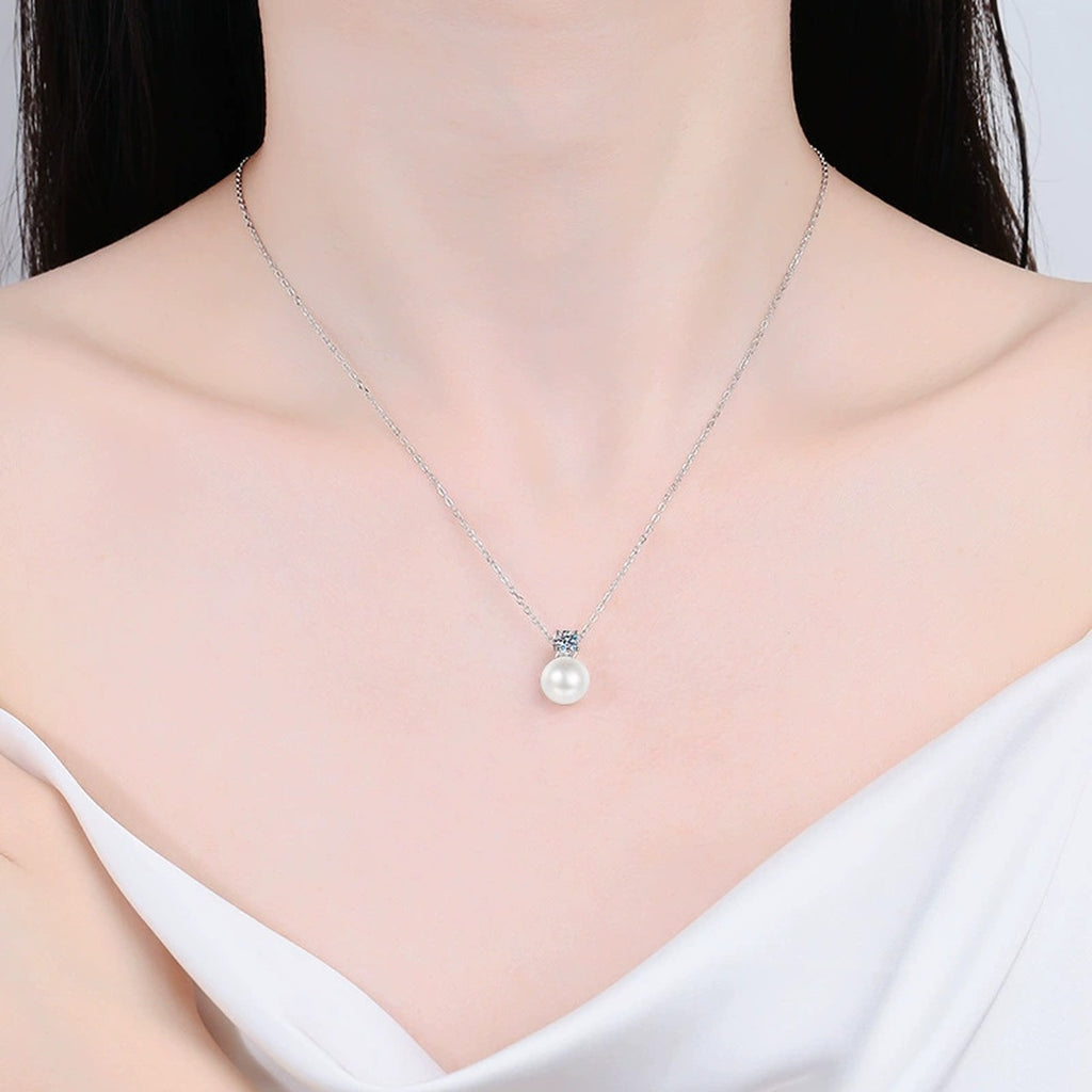 Petite Round Moissanite Pendant Necklace in Platinum-Plated S925 Sterling Silver worn by model at neckline