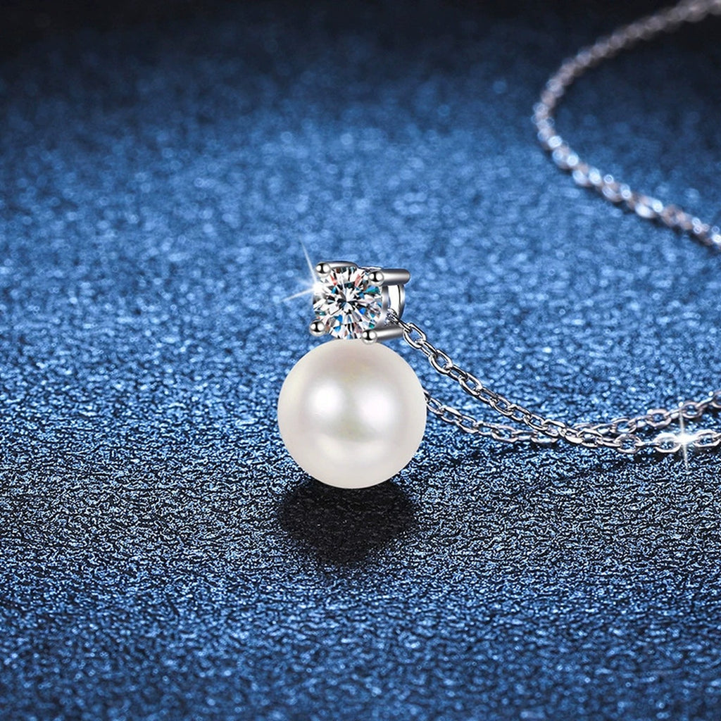 Petite Round Moissanite Pendant Necklace in Platinum-Plated S925 Sterling Silver blue background angled detail view