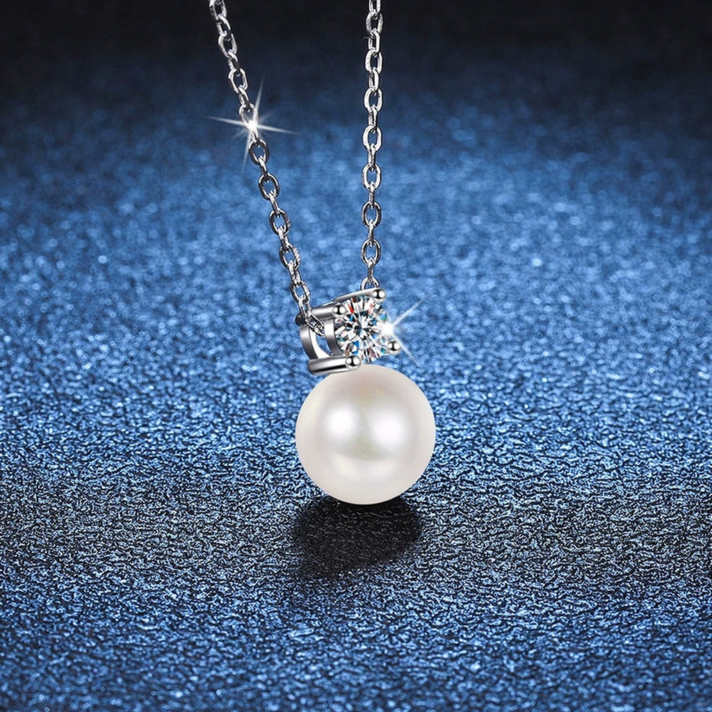 Petite Round Moissanite Pendant Necklace in Platinum-Plated S925 Sterling Silver blue background close-up view