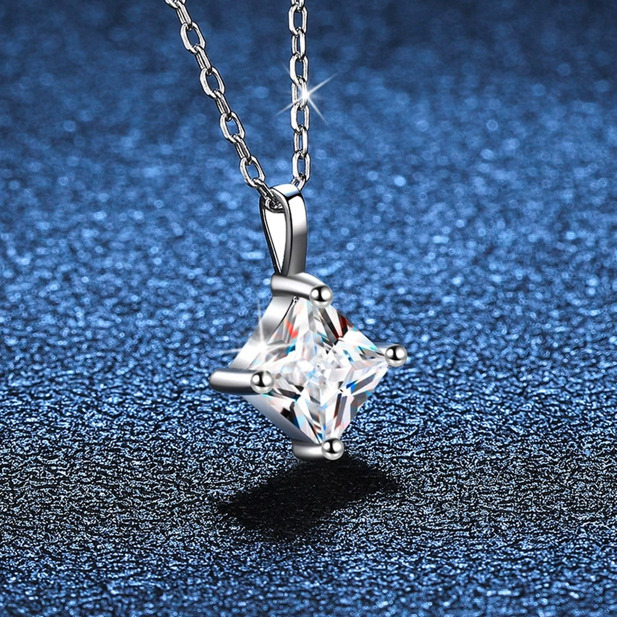 Princess-Cut Moissanite Pendant Necklace in Platinum-Plated S925 Sterling Silver blue background close-up view