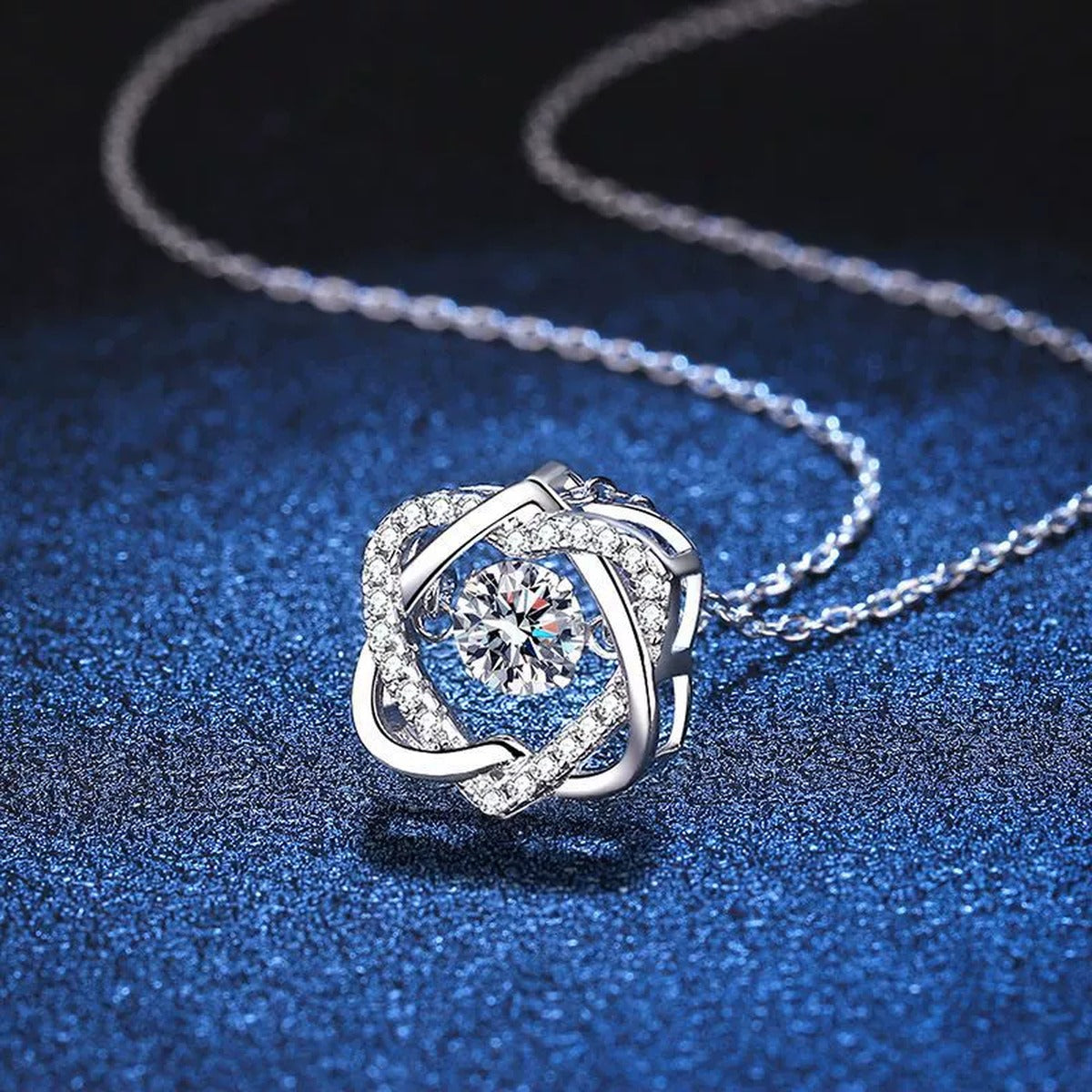 Swirl Round Moissanite Pendant Necklace in Platinum-Plated S925 Sterling Silver blue background angled detail view