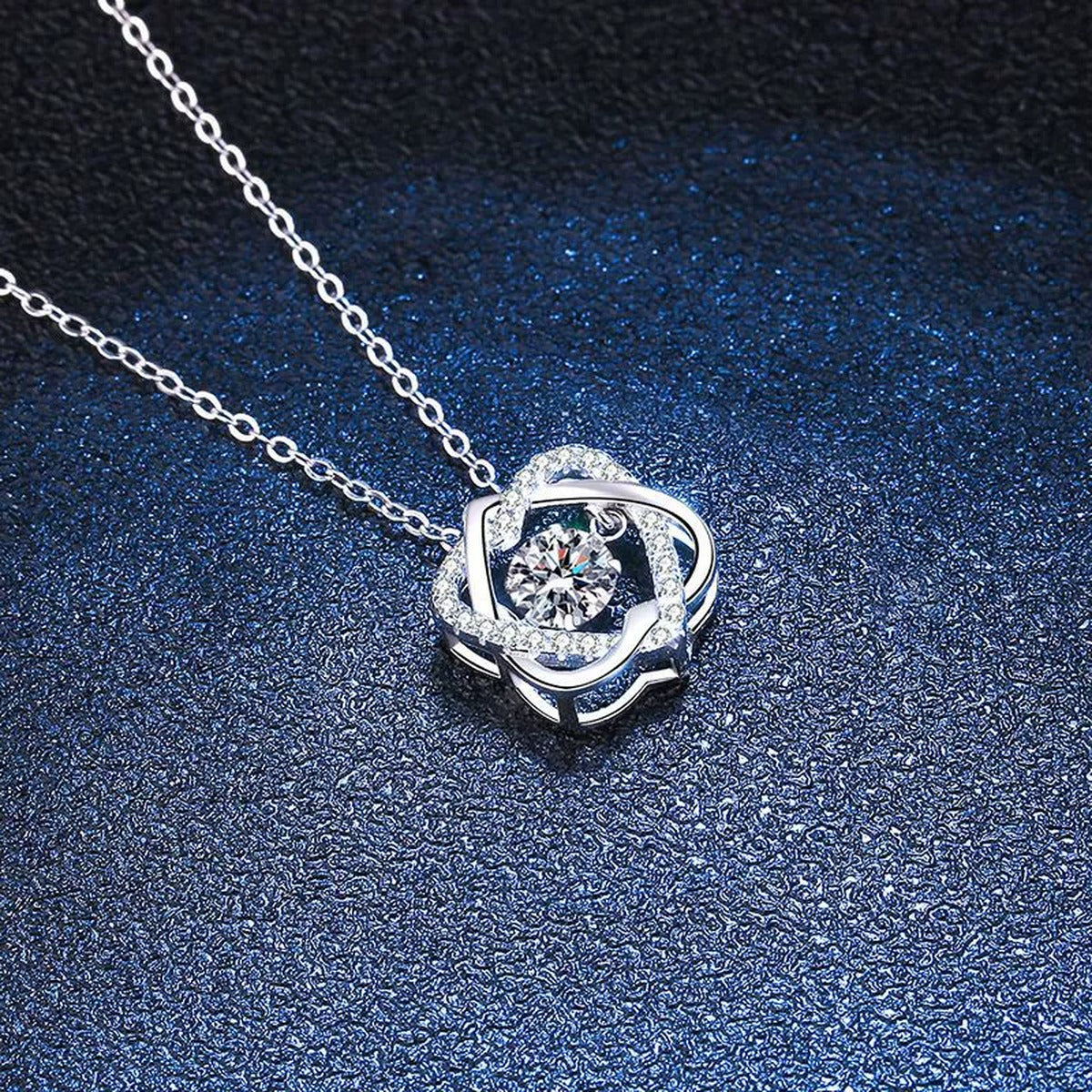 Swirl Round Moissanite Pendant Necklace in Platinum-Plated S925 Sterling Silver blue background close-up view
