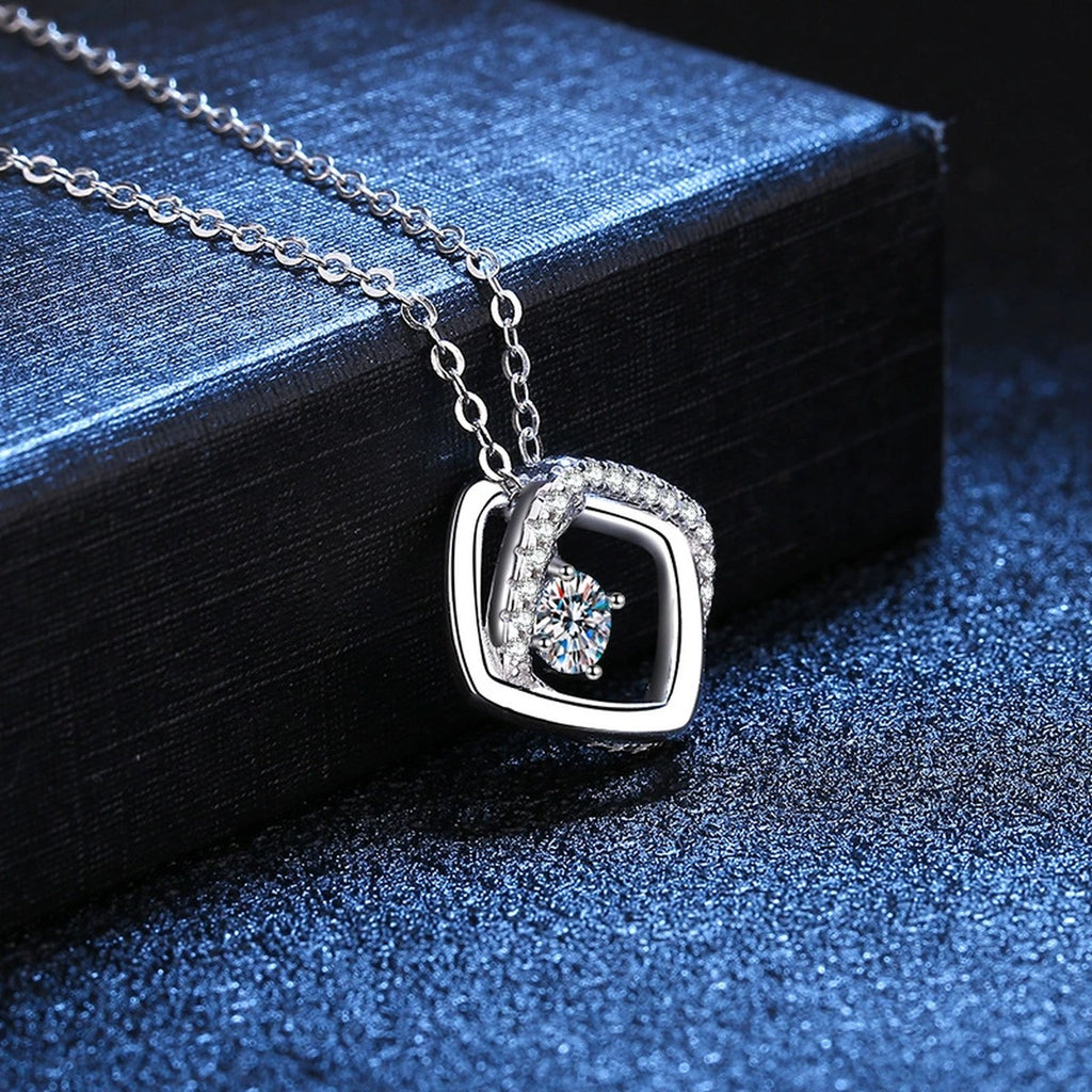 Geometric Halo Moissanite Pendant Necklace in Platinum-Plated S925 Sterling Silver blue background angled detail view