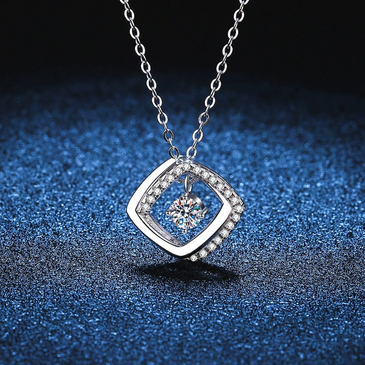 Geometric Halo Moissanite Pendant Necklace in Platinum-Plated S925 Sterling Silver blue background close-up view
