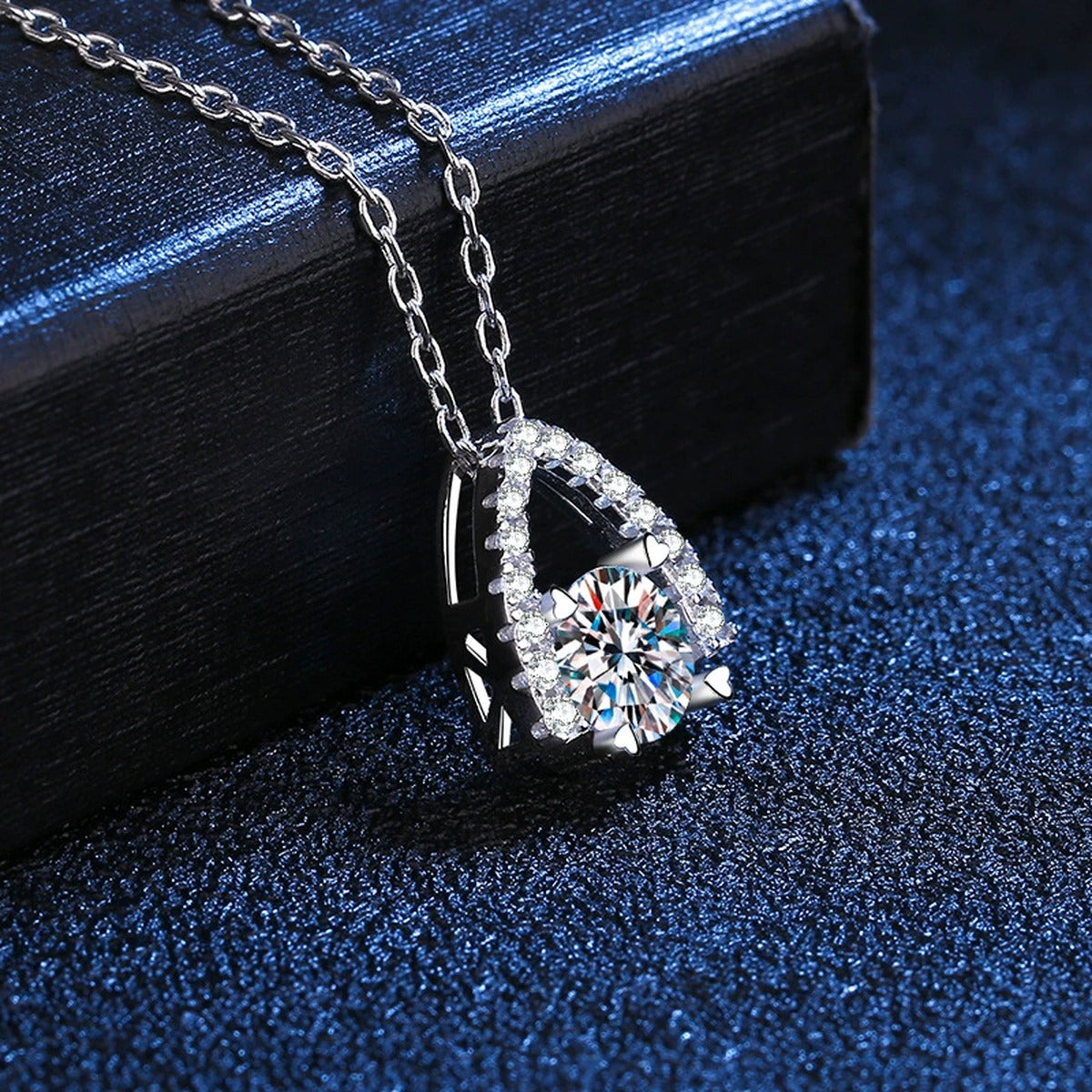 Arch Halo Moissanite Pendant Necklace in Platinum-Plated S925 Sterling Silver blue background close-up view