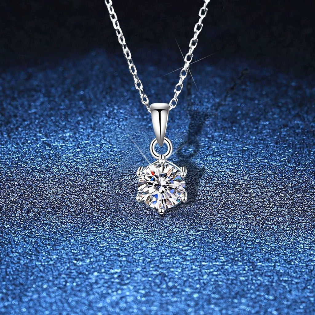 Round Moissanite Pendant Necklace in White Gold-Plated S925 Sterling Silver blue background angled view