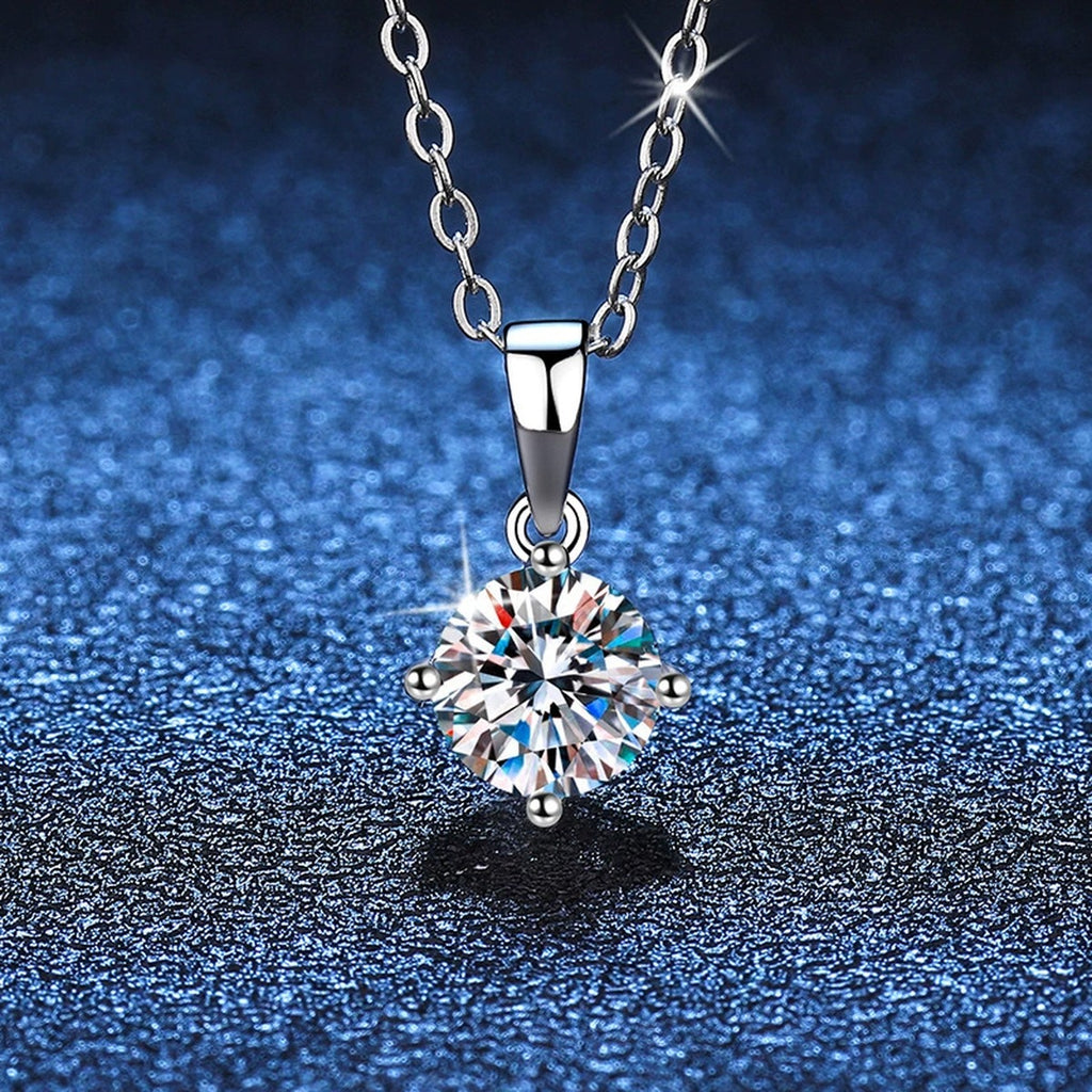 Round Moissanite Solitaire Pendant Necklace in Platinum-Plated S925 Sterling Silver blue background angled detail view