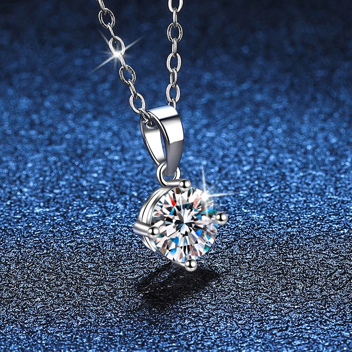 Round Moissanite Solitaire Pendant Necklace in Platinum-Plated S925 Sterling Silver blue background close-up view