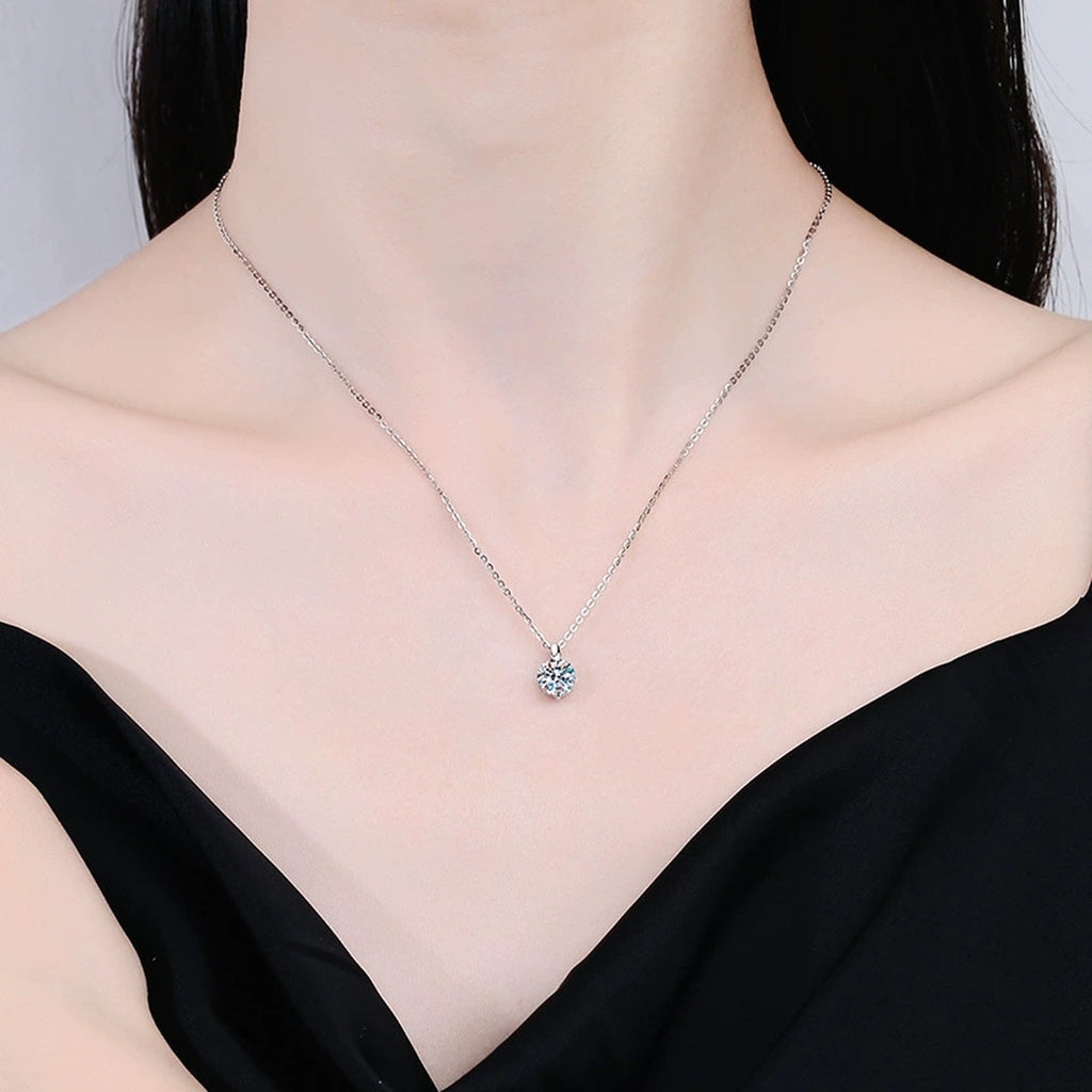 Round Moissanite Solitaire Pendant Necklace in Platinum-Plated S925 Sterling Silver worn by model at neckline