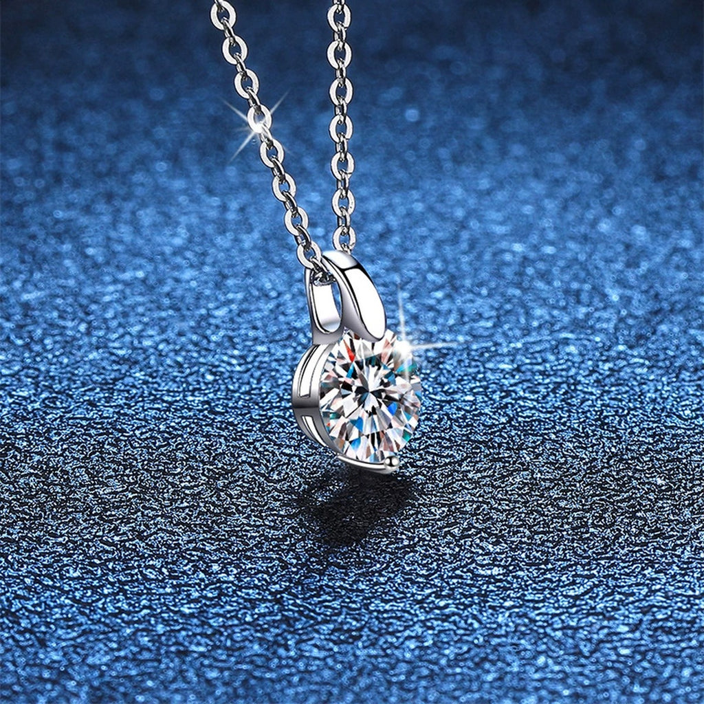 Round Moissanite Solitaire Pendant Necklace in Platinum-Plated S925 Sterling Silver blue background angled detail view
