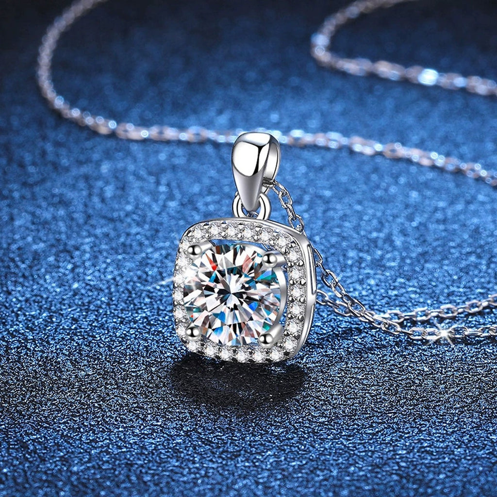 Round Moissanite Pendant Necklace in Platinum-Plated S925 Sterling Silver blue background angled detail view