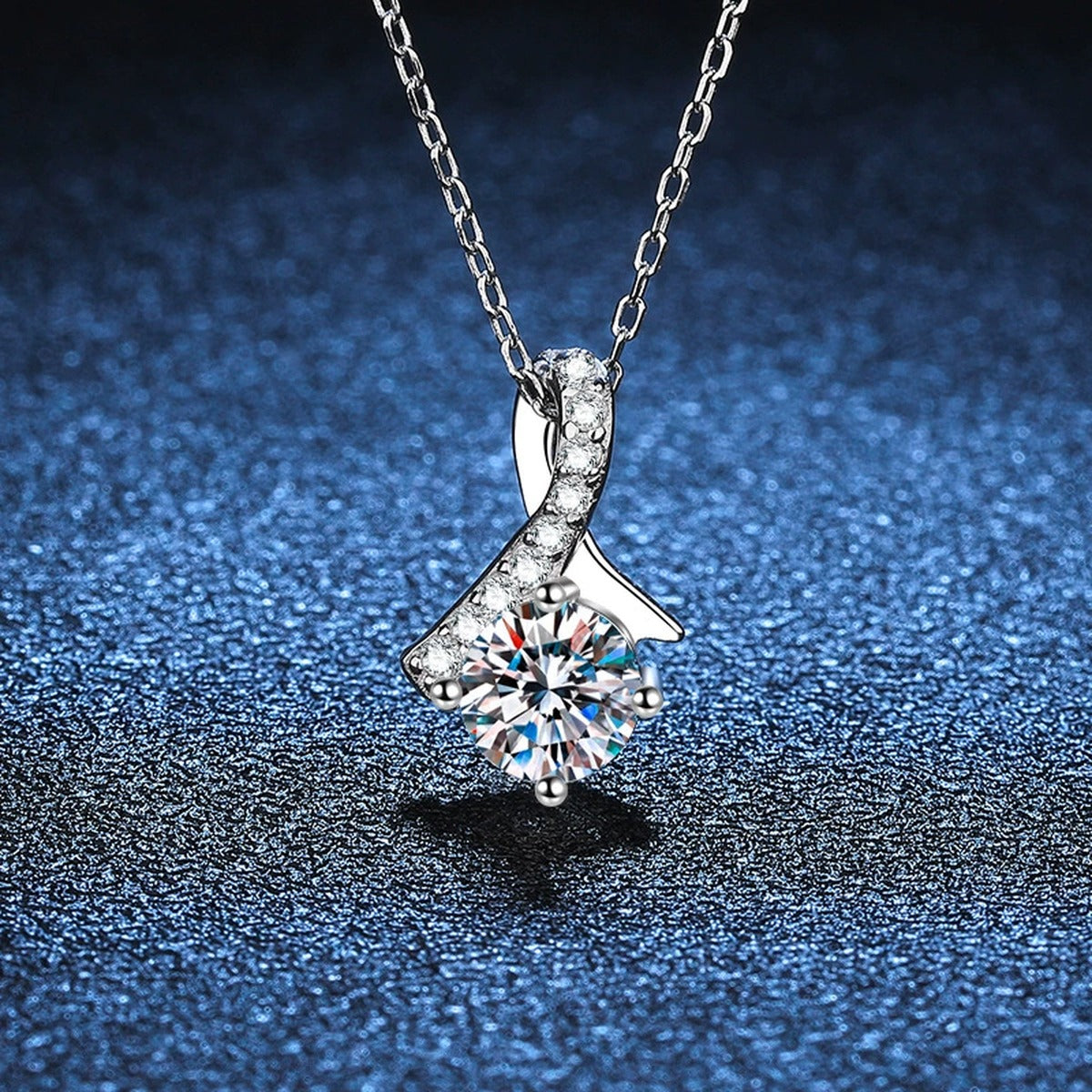 Ribbon Round Moissanite Pendant Necklace in Platinum-Plated S925 Sterling Silver blue background angled detail view